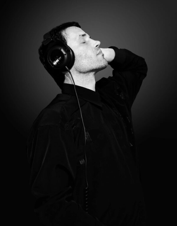 Immersive headphone portrait highlighting COCOLOGO sustainable fashion and eco-conscious knitwear craftsmanship