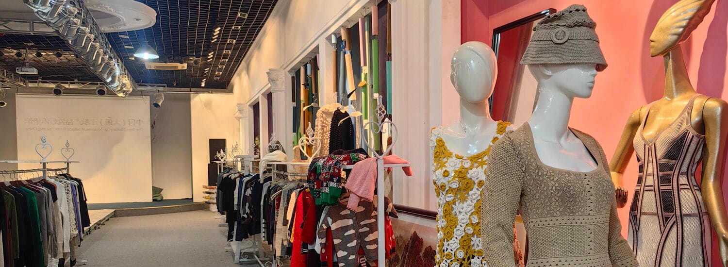 The image presents a clothing store with two rows of mannequins on display.