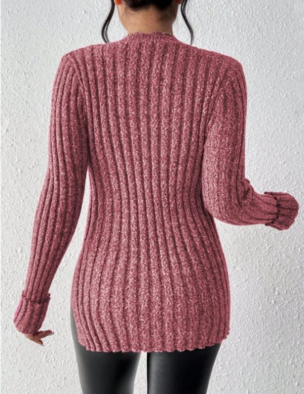 A person wearing a pink sweater with long sleeves and a ribbed texture.